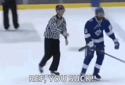 Referee Next to Hockey Player on Ice