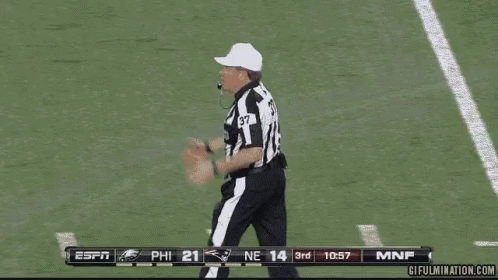 Referee Number 37 Saying Foul on Football Field
