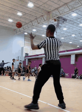 Referee on Basketball Court With UPMC Sign