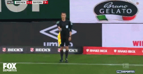 Referee on Soccer Field with Bruno Gelato Sign