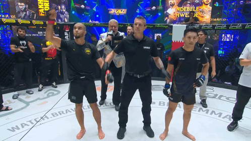 Referee Raising Fighter's Hand in Cage With Braz Banner