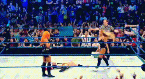 Referee Standing Over Downed Wrestler in Ring