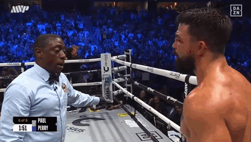 Referee Talking to Boxer in Ring