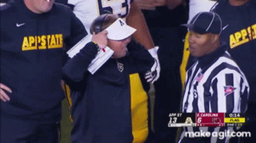 Referee Talking to Coach Wearing AP State Shirt