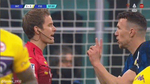 Referee Talking to Player Soccer Game