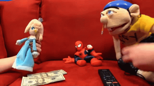 Remote Control Next to Spiderman and Princess Puppets