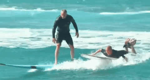 Rfk Catches Waves With Surfing GIF
