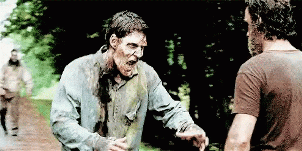 Rick Grimes Walking Dead Pushing Zombie GIF