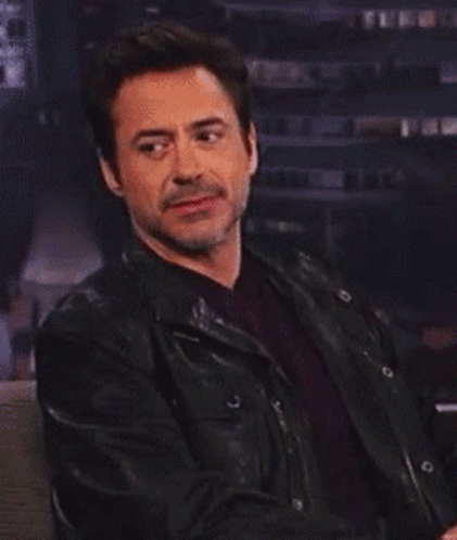 Robert Downey Jr. Is Wearing A Black Leather Jacket And A Red Shirt GIF