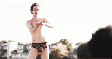 Robert Sheehan Putting Lotion On Thigh GIF