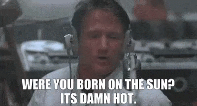 Robin Williams Is Wearing Headphones And Talking Into A Microphone In A Room . GIF