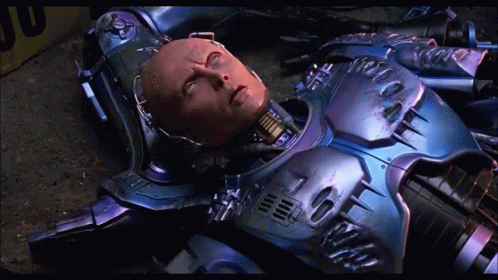Robot Laying on Ground With Yellow Box