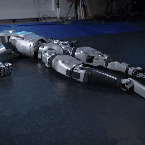 Robot Lying on Black Mat