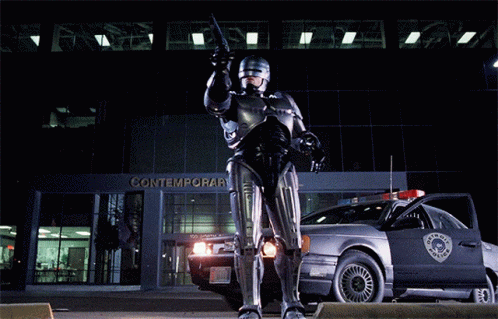 Robot Standing in Front of Contemporar Building