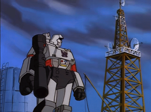 Robot Standing in Front of Tower With Satellite Dishes