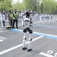 Robot Walking in Parking Lot as People Watch