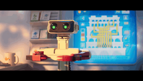 Robot With Green Eyes Standing in Front of Monitor
