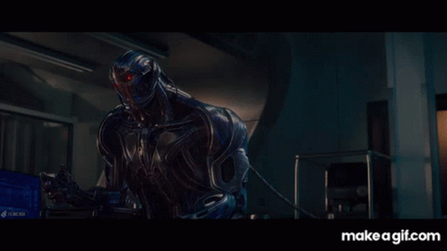 Robot With Red Eyes Sitting in Dark Room