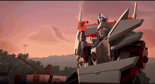 Robot With Red Head in Front of Shipping Containers