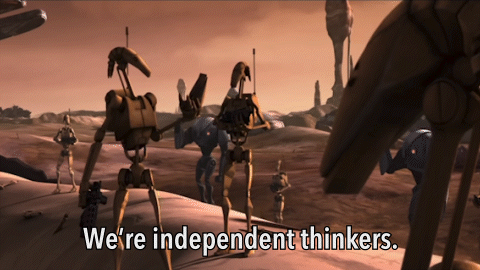 Robots Standing in Desert With We Are Independent Thinkers