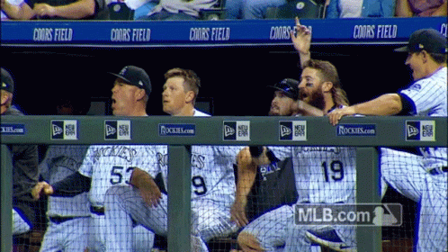Rockies Baseball Players Sitting on Dugout