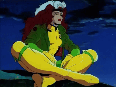 Rogue From The X-Men Sits On A Rock With Her Legs Crossed GIF