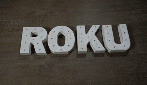 Roku White Letters on Wooden Surface