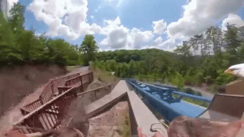 Roller Coaster Going Down Hill With Bridge