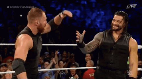 Roman Reigns Hugging Man In Wrestling Ring GIF
