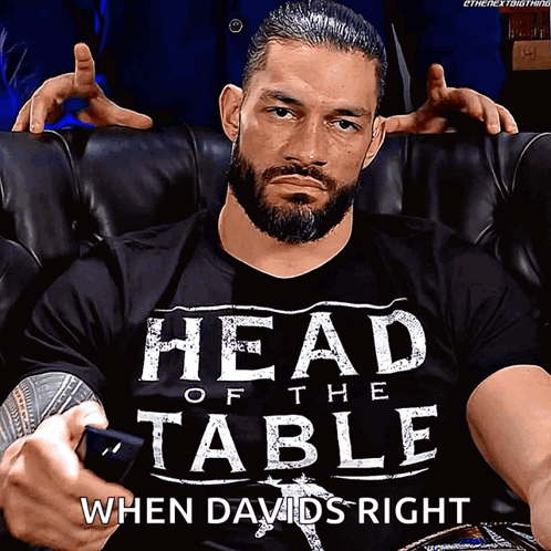 Roman Reigns Is Wearing A Shirt That Says Head Of The Table When Davids Right GIF