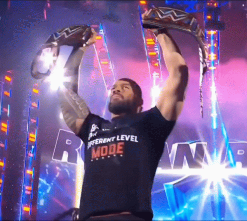 Roman Reigns Raises 2 Champions Belt GIF