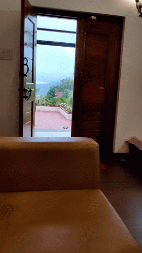 Room With Couch and Open Door View