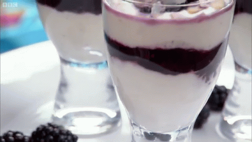 Rotating Glasses Containing Berries And Cream GIF