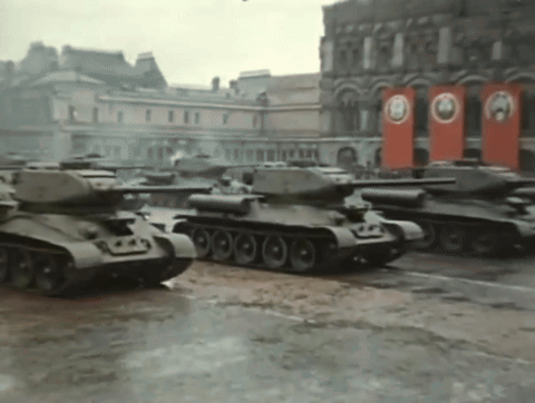 Row of Black and White Tanks Driving in Snow