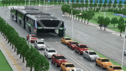 Row Of Cars Driving Down Street With CCTV News Sign GIF
