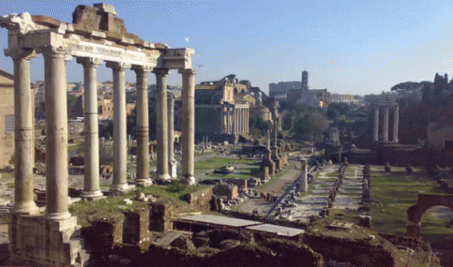 Row of Columns in Ruined Area With Building