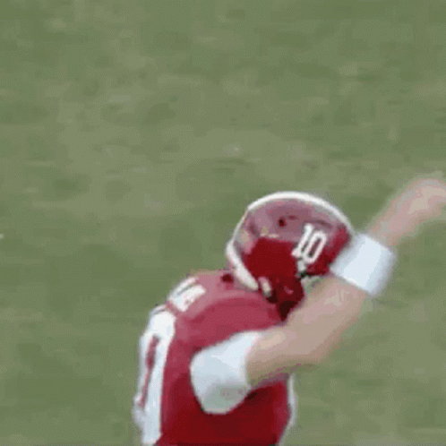 Running Football Player in Red Uniform and Helmet