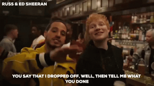 Russ And Ed Sheeran Are Posing For A Picture In Front Of A Bar GIF