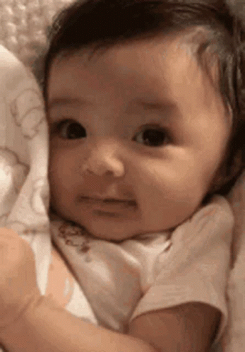 Sad Baby Lying on Blanket