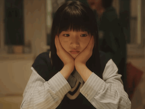 Sad Girl With Hands On Face GIF
