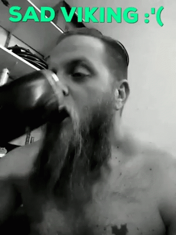 Sad Viking Man With Beard Drinking From Cup GIF