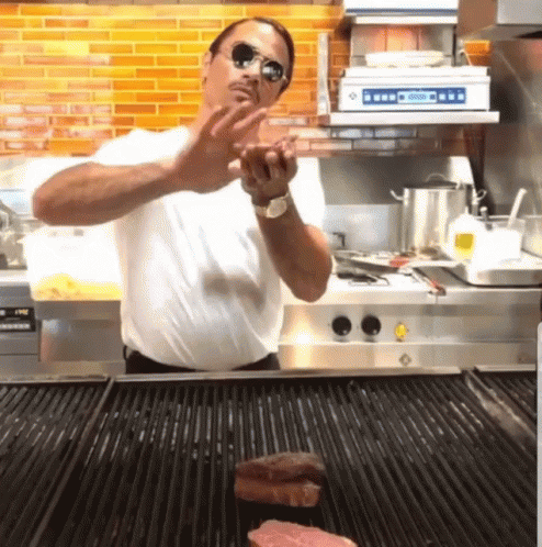 Salt Bae Tossing Meat On Grill GIF