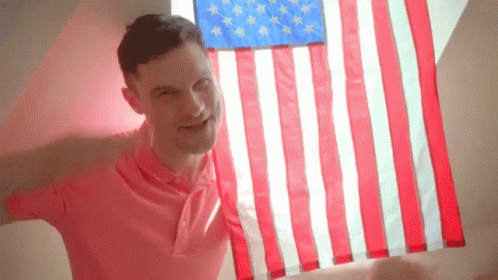 Saluting And Holding American Flag Waving GIF