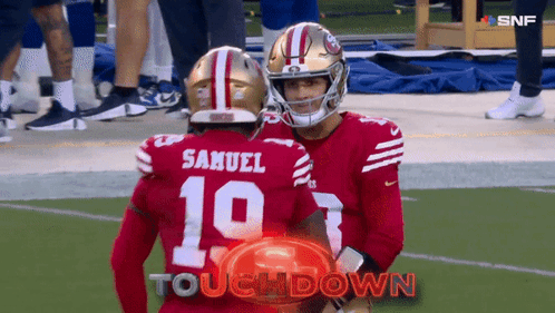 Samuel And Number 10 Are Hugging Each Other On The Football Field GIF