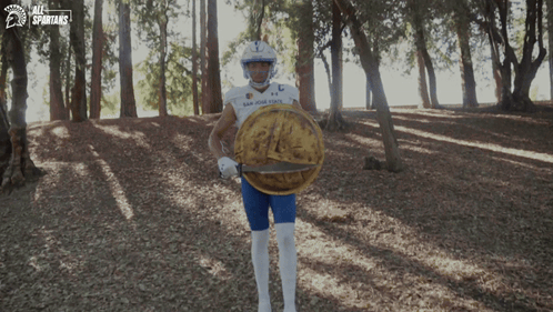 San Diego State Football Player Holding Shield in Woods