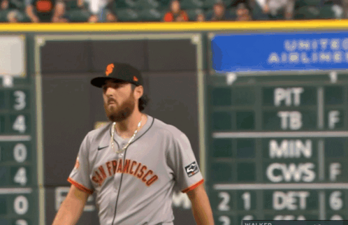 San Francisco Baseball Player Standing in Front of Scoreboard