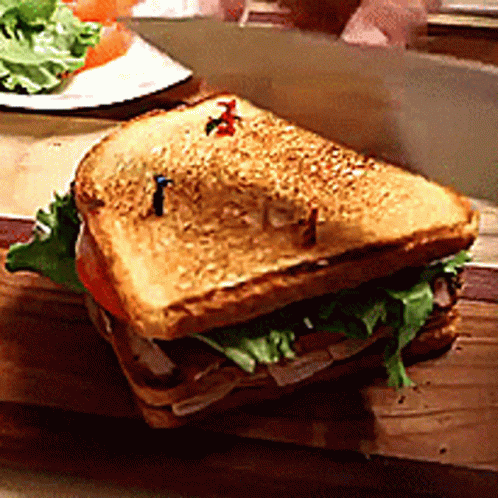 Sandwich With Lettuce and Tomatoes on Cutting Board