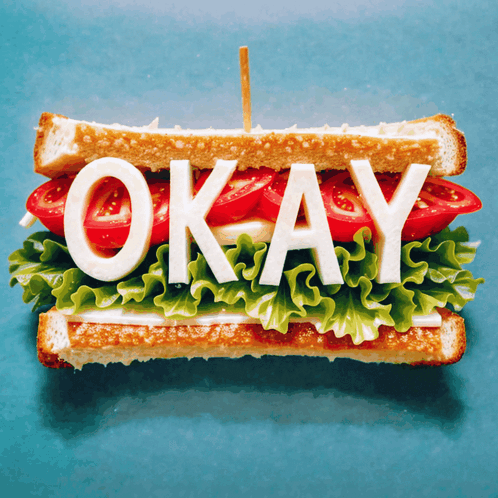 Sandwich With Lettuce Tomatoes and Cheese Saying Okay