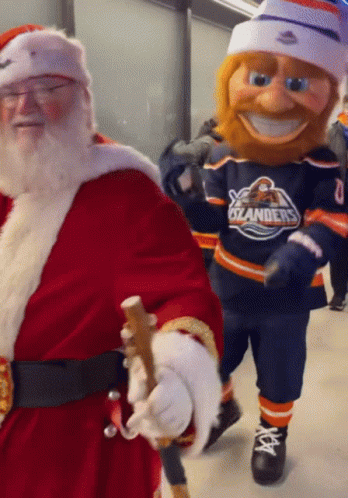 Santa Claus Walking Next to Oilers Mascot