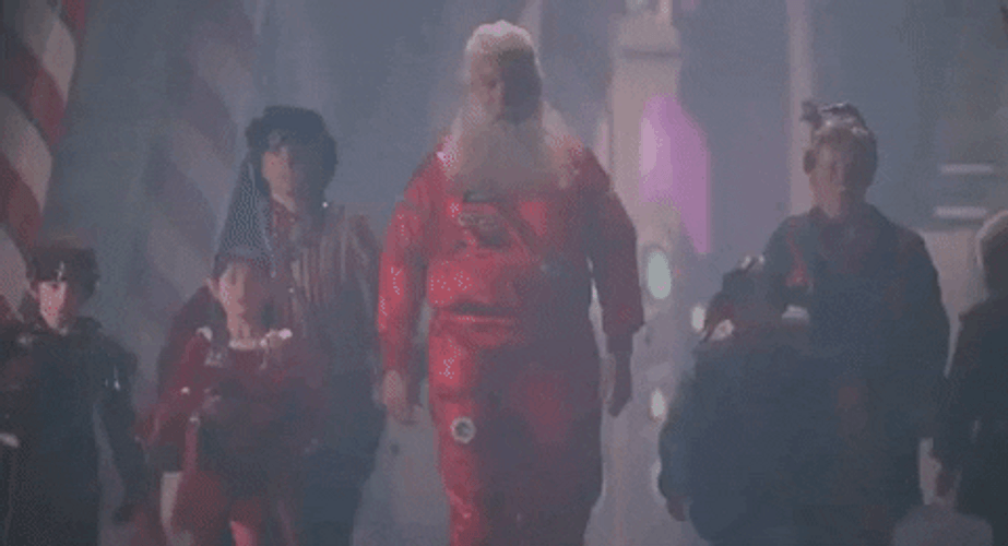 Santa Moving With His Assistants GIF